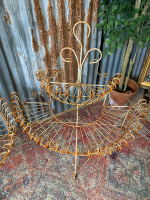 A pair of white wirework demi-lune plant stands