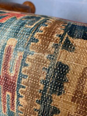 A large kilim-style footstool on cabriole legs