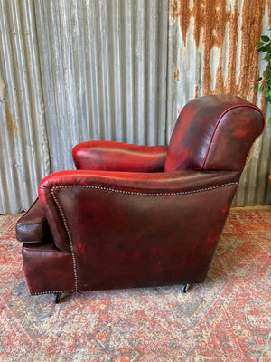 An oxblood red leather club chair