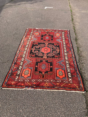 A Turkish red ground rug ~ 211cm x 138cm