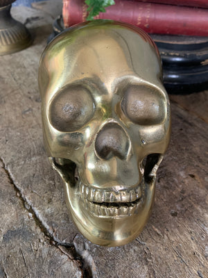 A life-size brass human skull model