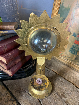 A gilt refraction candlestick with sunburst detail