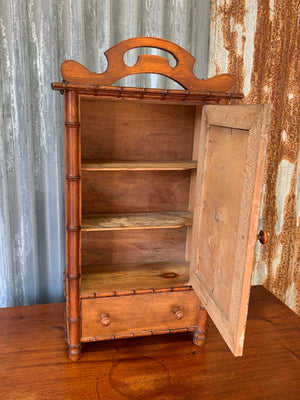 A small French faux bamboo mirrored cabinet