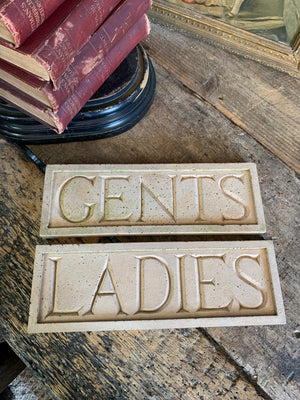 A pair of cast stone plaques ~ "LADIES" & "GENTS"