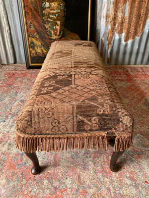 A large Persian carpet footstool