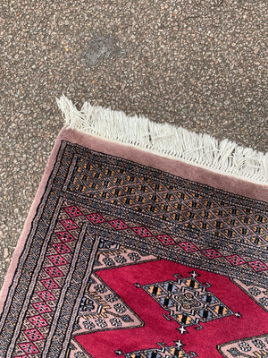 A long pink ground Persian runner rug ~ 318cm x 83cm