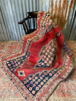 A rectangular red ground Persian rug - 190cm x 128cm