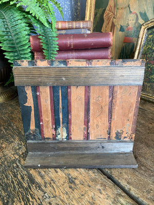 A wood and leather book spine hideaway panel ~B