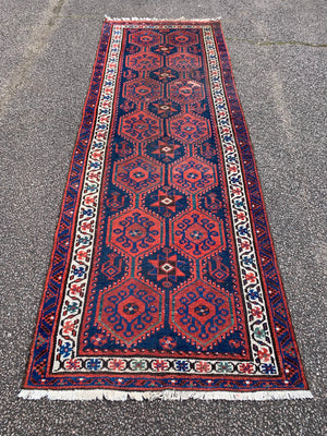 A long red ground blue Persian runner rug ~ 304cm x 104cm