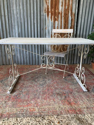 A white garden table and chairs set