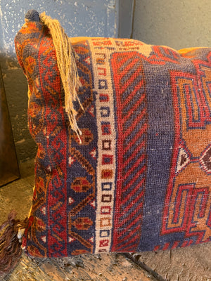 A large Persian carpet cushion