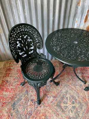 A green garden table and chairs set