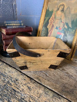 A wooden two tiered housemaid's trug