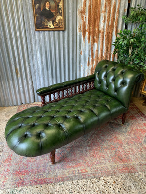 A Victorian-style green leather chaise longue