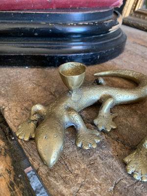 A pair of brass candlesticks in the form of lizards