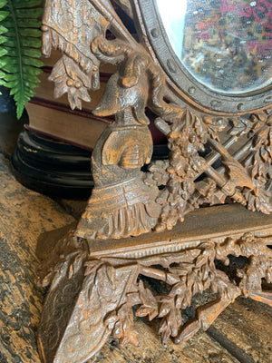 A cast iron table top mirror