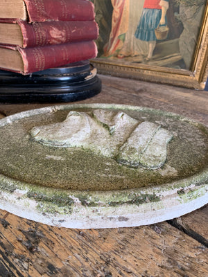 An oval cast stone plaque depicting a dog's head in profile ~B