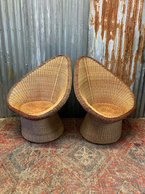 A pair of wicker egg chairs