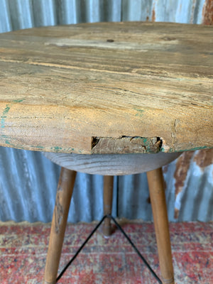 A sculptor's stand with circular oak top