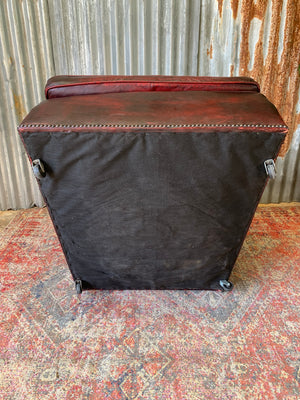 An oxblood red leather club chair