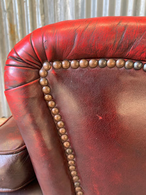 An oxblood red leather club chair