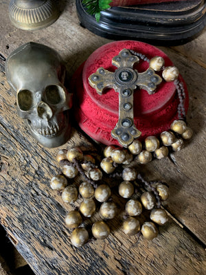 A set of oversized wooden rosary beads with memento mori motif