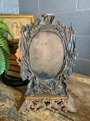 A cast iron table top mirror