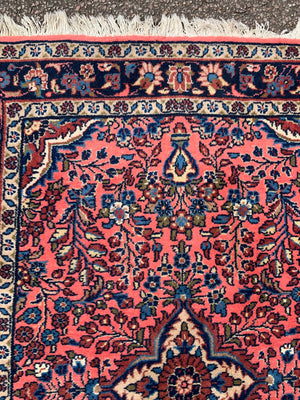 A Persian pink ground wool rug ~ 155cm x 105cm