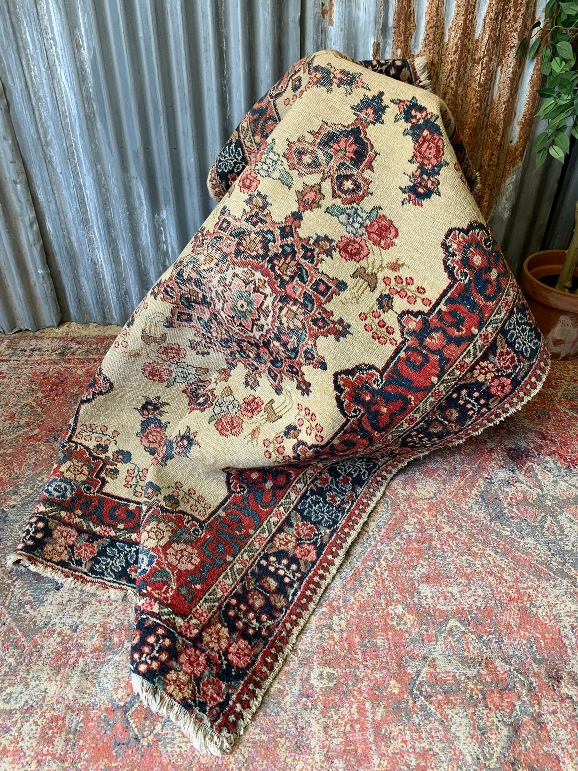 A Persian cream ground rug ~ 194cm x 133cm