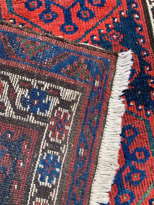 A long red ground blue Persian runner rug ~ 304cm x 104cm