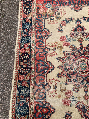 A Persian cream ground rug ~ 194cm x 133cm