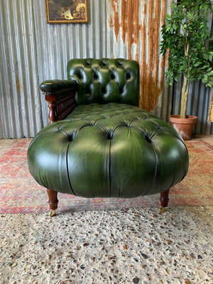 A Victorian-style green leather chaise longue