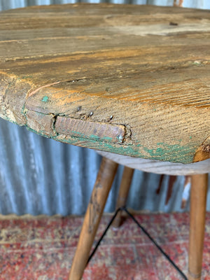 A sculptor's stand with circular oak top