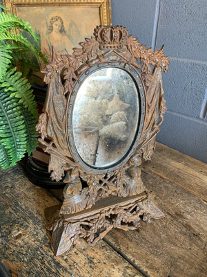 A cast iron table top mirror