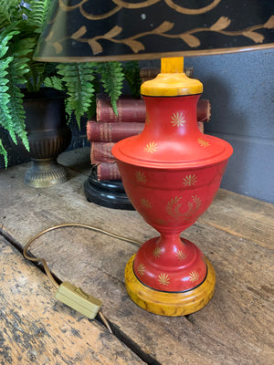 A pair of red and black toleware lamps