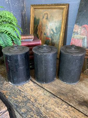 A set of three lidded wooden apothecary jars