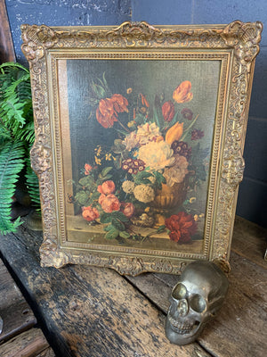 A framed floral oleograph