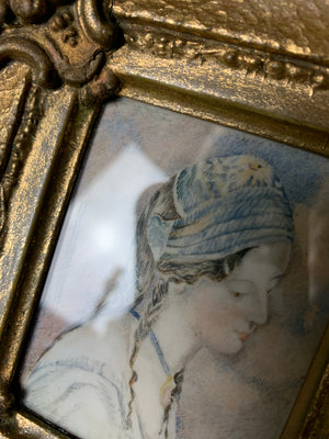 A framed miniature of a woman in blue ~ side profile