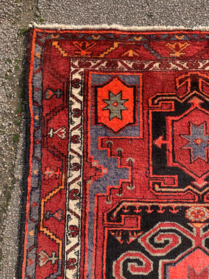 A Turkish red ground rug ~ 211cm x 138cm