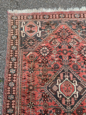 A Persian red ground rectangular rug- 161cm x 117cm