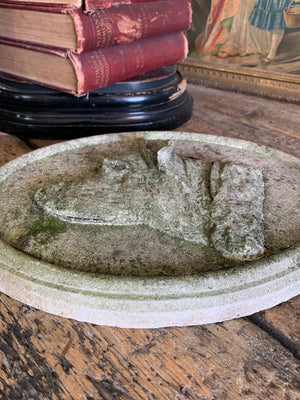 An oval cast stone plaque depicting a dog's head in profile ~C