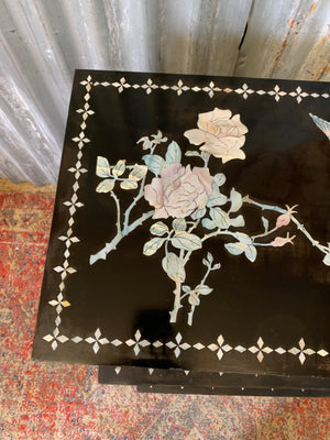 A nest of four black lacquered chinoiserie tables