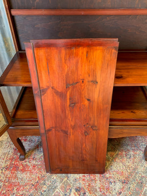 A mahogany double-fronted glass display cabinet with two drawers