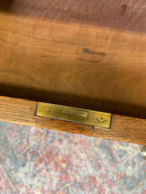 A blonde wood desk on castors