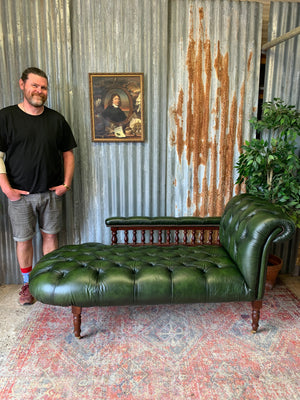 A Victorian-style green leather chaise longue