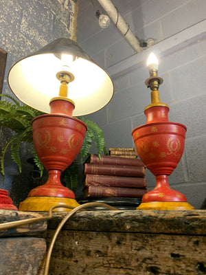 A pair of red and black toleware lamps
