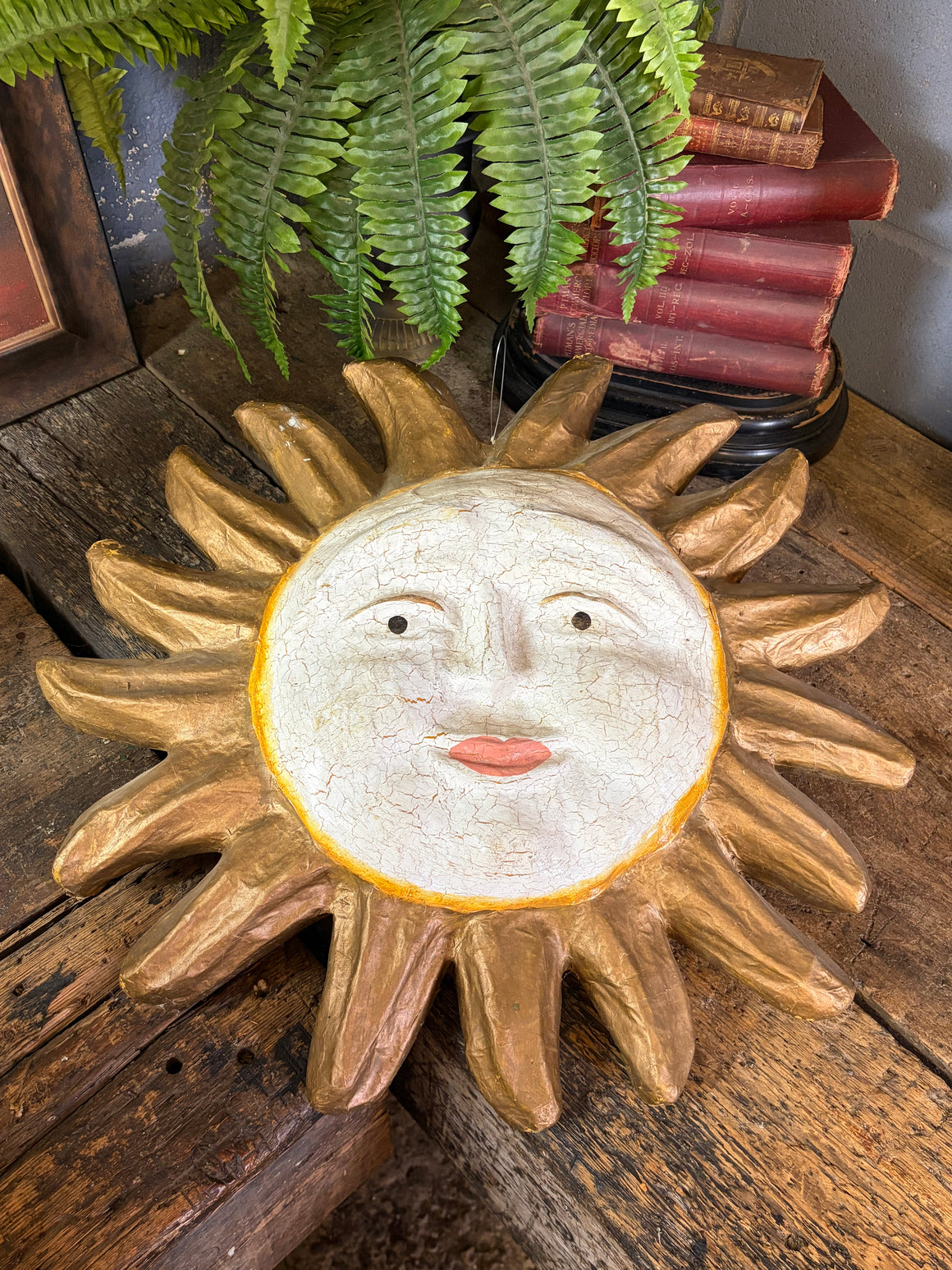A papier-mache sun model