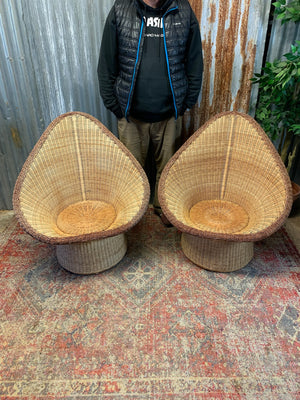 A pair of wicker egg chairs