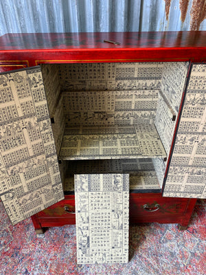 A red and gold lacquered chinoiserie cabinet