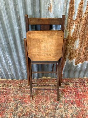 An Edwardian oak folding chapel chair by Mealing Bros